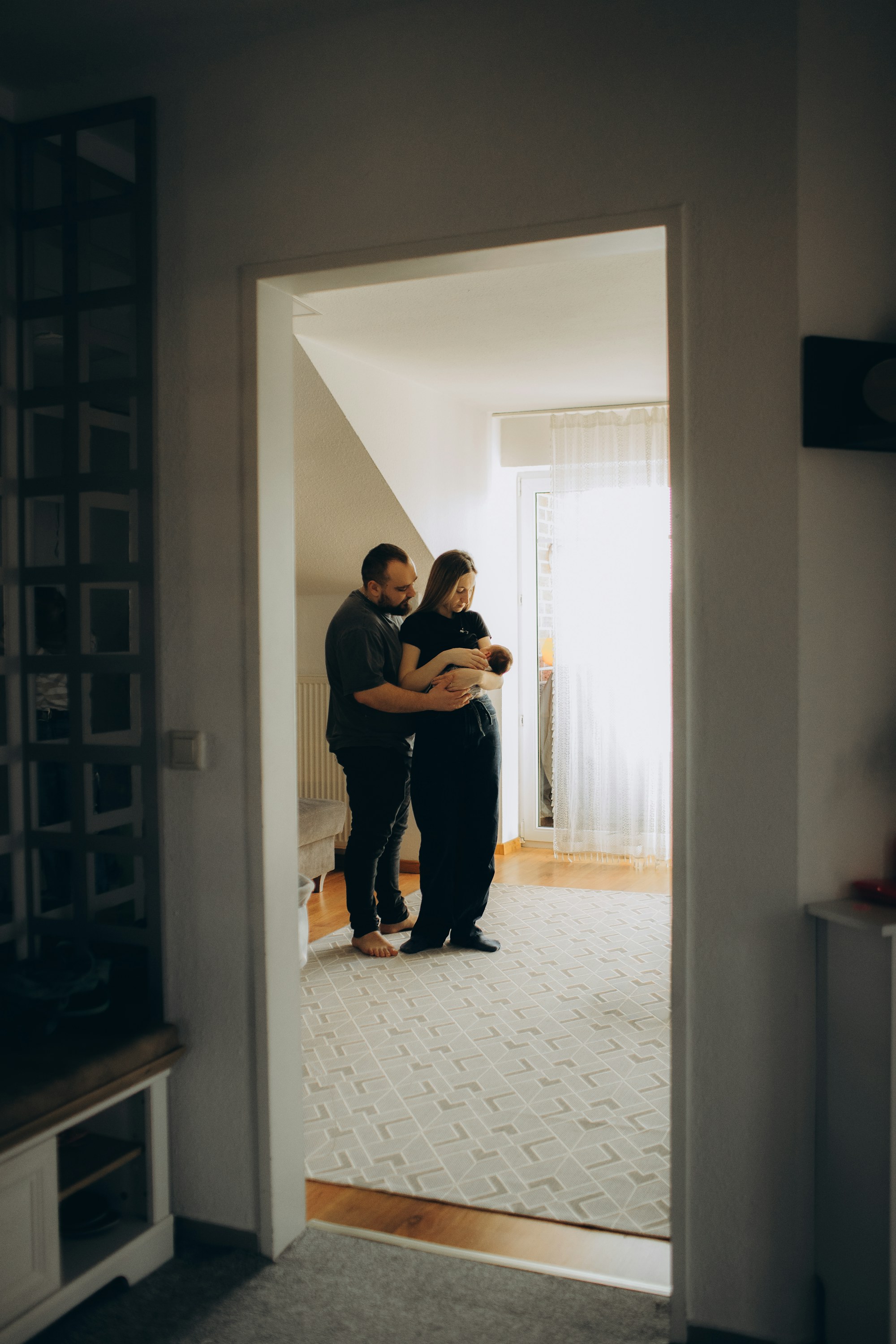Parents holding their newborn at home