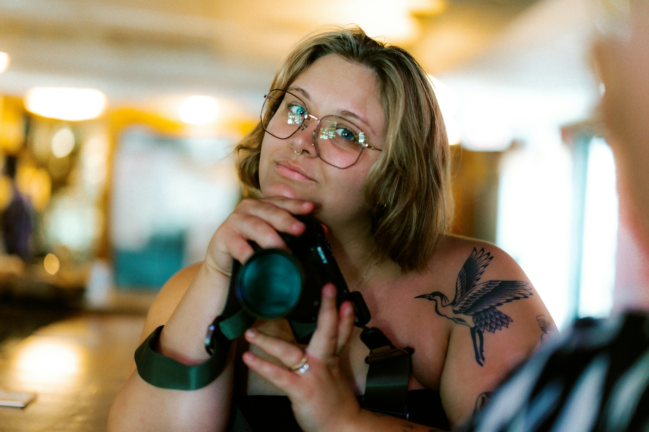 Photographer holding a camera in soft natural light